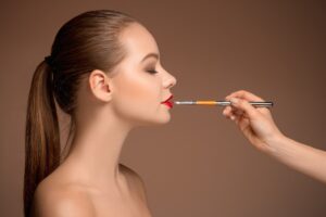 beautiful-female-lips-with-make-up-brush.jpg  