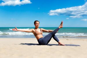 woman-doing-pilates-shore-beach-sportswear.jpg  